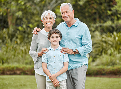 Buy stock photo Shot of a senior couple standing outside with their grandson