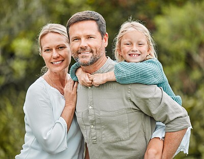 Buy stock photo Shot of a couple and their daughter spending the day outdoors