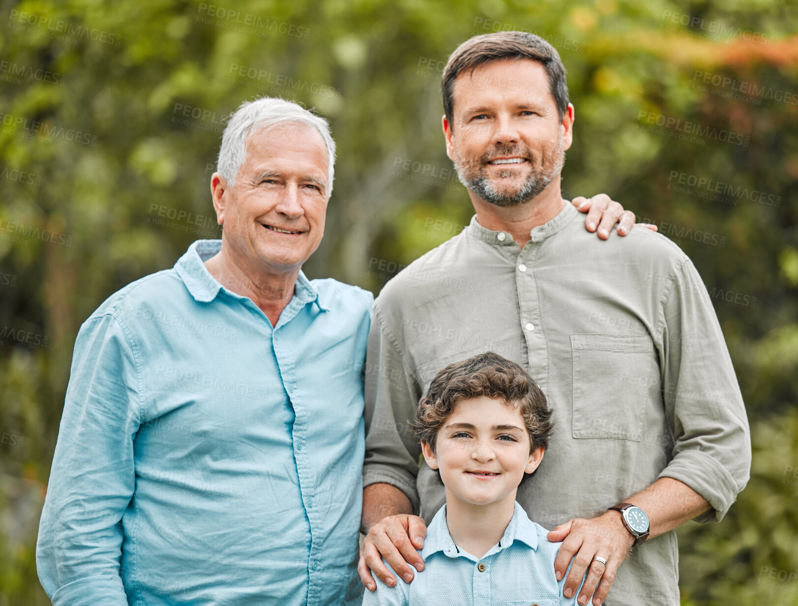 Buy stock photo Shot of a boy standing outside with his father and grandfather