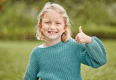 Buy stock photo Shot of an adorable little girl showing thumbs up while  standing outside