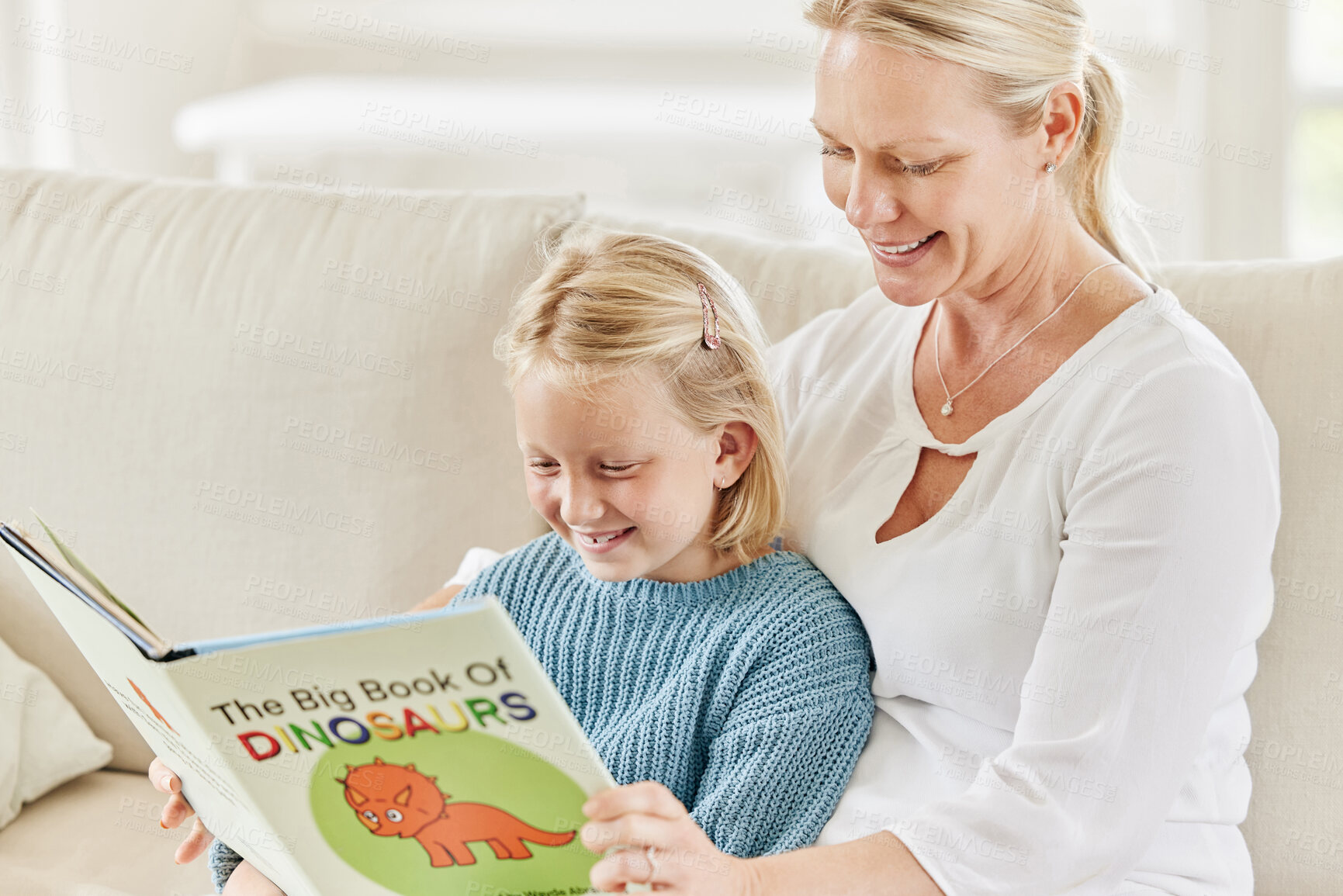 Buy stock photo Teaching, happy girl and mother reading book on couch for learning, bonding and education in home together. Smile, family and mom with kid for storytelling, fantasy fairytale or child development