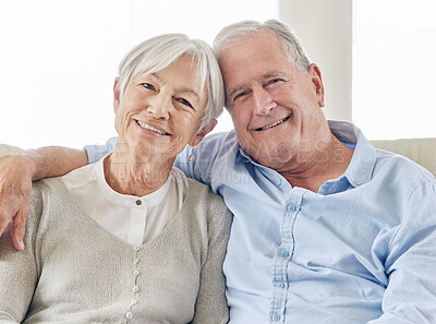 Buy stock photo Shot of a mature couple being affectionate on the sofa at home