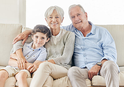 Buy stock photo Shot of a mature couple bonding with their grandson on the sofa at home