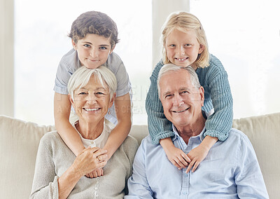 Buy stock photo Shot of a mature couple bonding with their grandkids at home