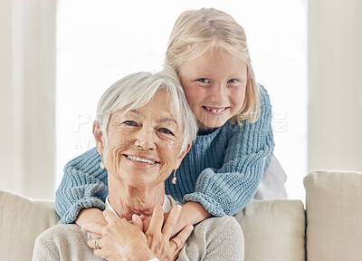 Buy stock photo Shot of a mature woman bonding with her grandchild on the sofa at home
