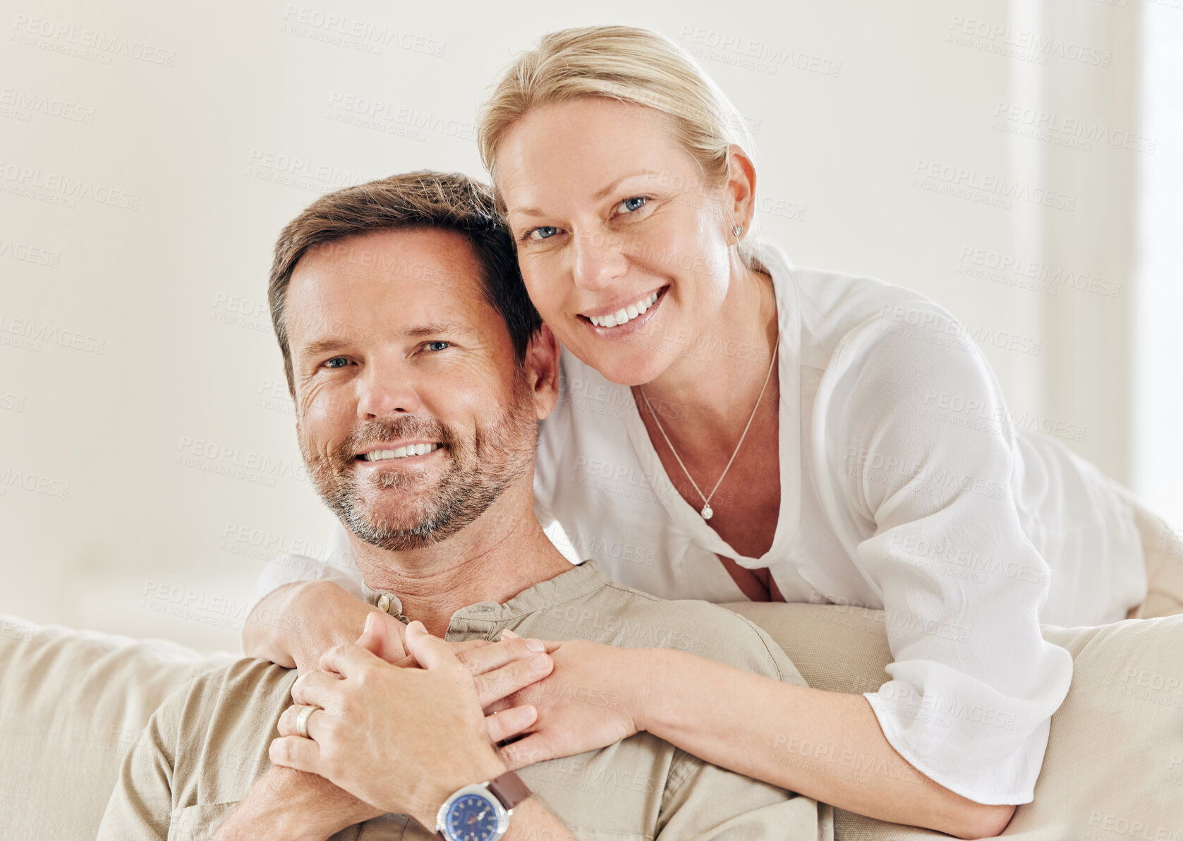 Buy stock photo Shot of a young couple being affectionate on the sofa at home