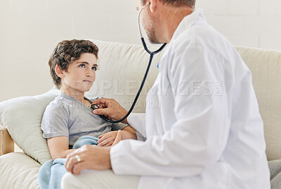 Buy stock photo Shot of a male doctor visiting a little boy at home