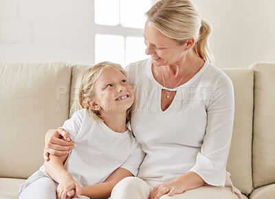 Buy stock photo Shot of a daughter and mother bonding on the sofa together at home
