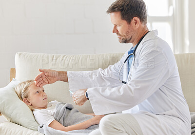 Buy stock photo Shot of a male doctor taking a little girls temperature at home