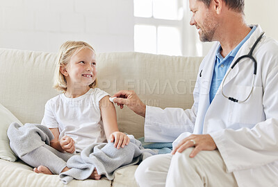 Buy stock photo Shot of a male doctor injecting a little girl at home