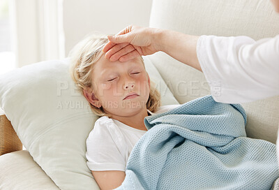 Buy stock photo Shot of a mother checking her daughters temperature on the sofa at home