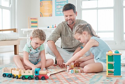 Buy stock photo Shot of a father sitting with his two daughters while they play with their toys