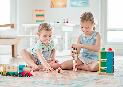 Buy stock photo Shot of two little girls playing with their toys at home