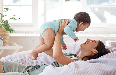 Buy stock photo Happy mother, play and holding baby on bed for love, care and quality time together at home. Mom, smile and carrying playful infant kid, newborn and laughing in bedroom for comfort, relax and support