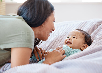 Buy stock photo Mom, baby and laughing on bed in home for love, care and quality time together for play, growth and kids development. Happy mother, infant child and fun with newborn girl, relax and smile in bedroom