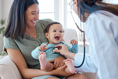 Buy stock photo Shot of a baby sitting on her mother's lap while being examined by a doctor