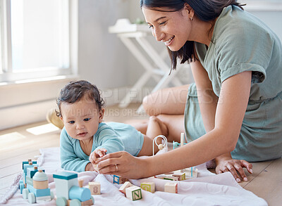 Buy stock photo Shot of a woman playing with her baby at home