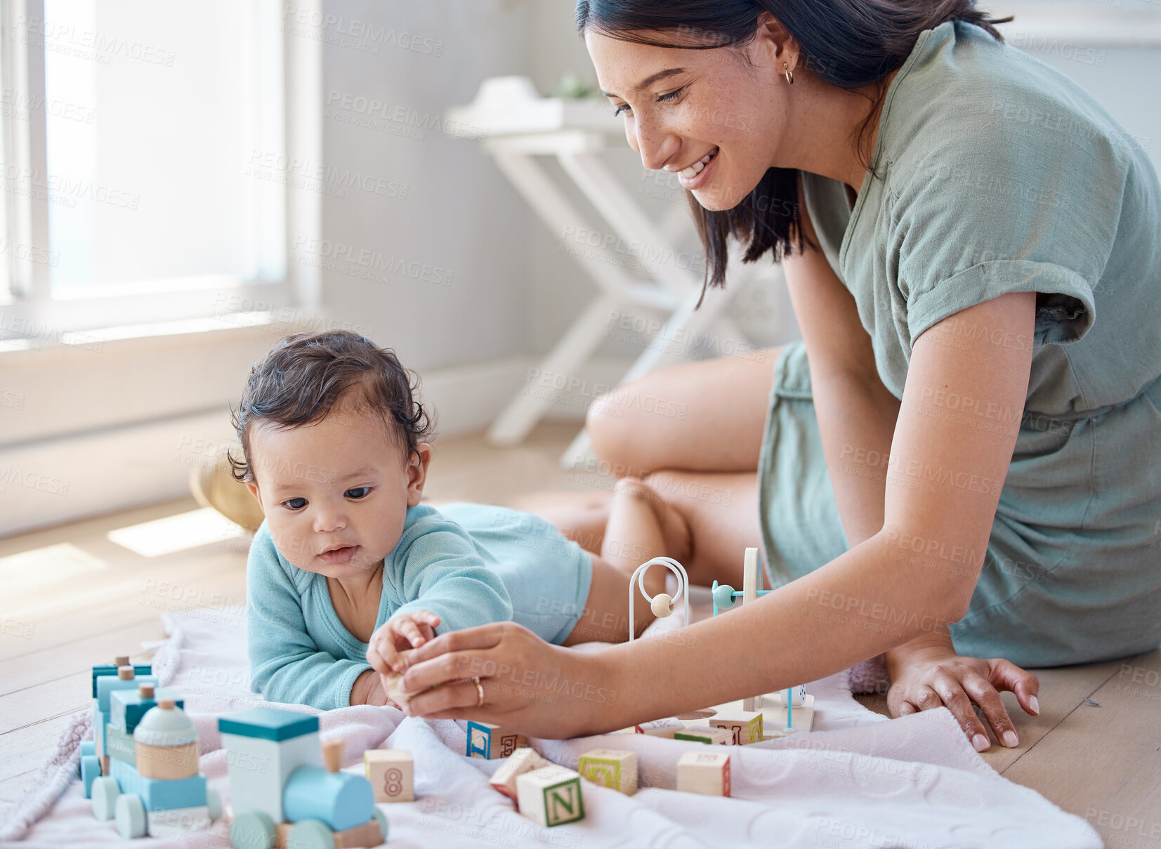 Buy stock photo Shot of a woman playing with her baby at home