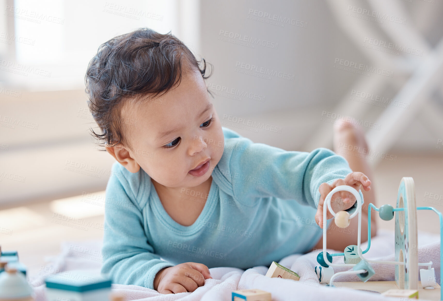 Buy stock photo Baby, playing and toys on floor in home with learning, development and morning in nursery. Child, infant and laying with motor skills, solution and touch with growth, game and explore in family house