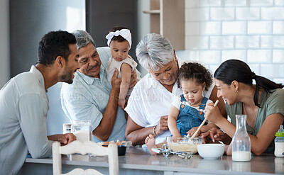 Buy stock photo Shot of a multigenerational family baking together in the kitchen