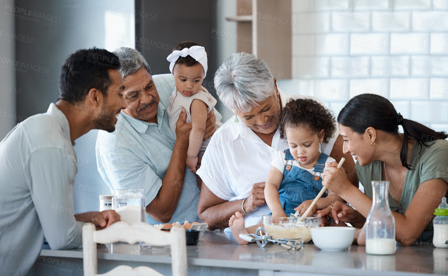 Buy stock photo Shot of a multigenerational family baking together in the kitchen