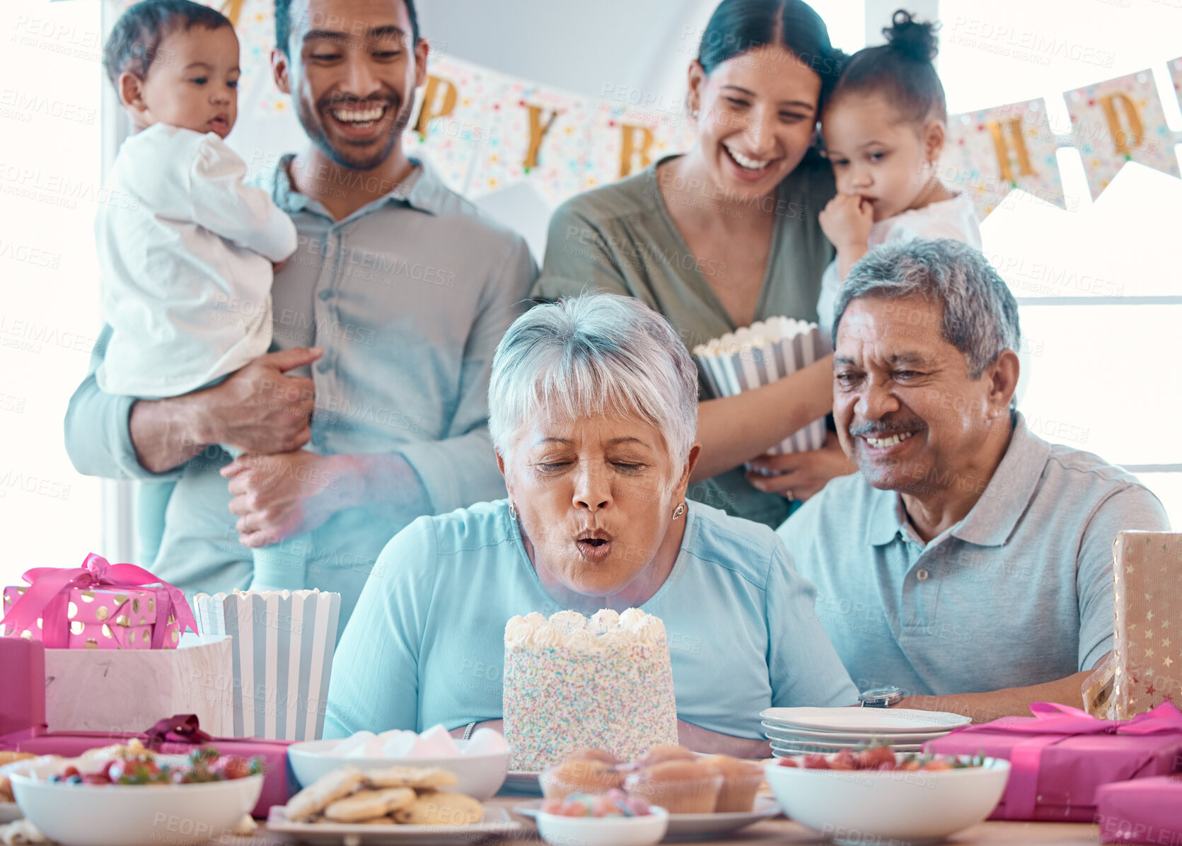 Buy stock photo Big family, senior couple and candle blowing with party, cake and love for home birthday celebration. Man, woman and parents with grandchildren, support and event for retirement and holiday bonding