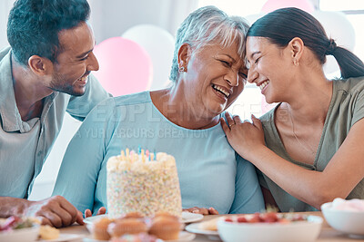 Buy stock photo Shot of two young adults celebrating a birthday with a mature woman at home