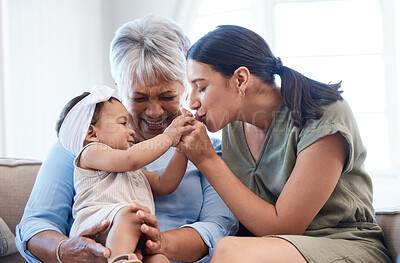 Buy stock photo Shot of a mature woman bonding with her daughter and granddaughter on the sofa