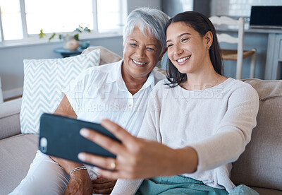 Buy stock photo Home, grandmother and smile for selfie with woman on sofa for profile picture, memories or social media. People, senior person and happy with granddaughter on couch in living room for bonding or care