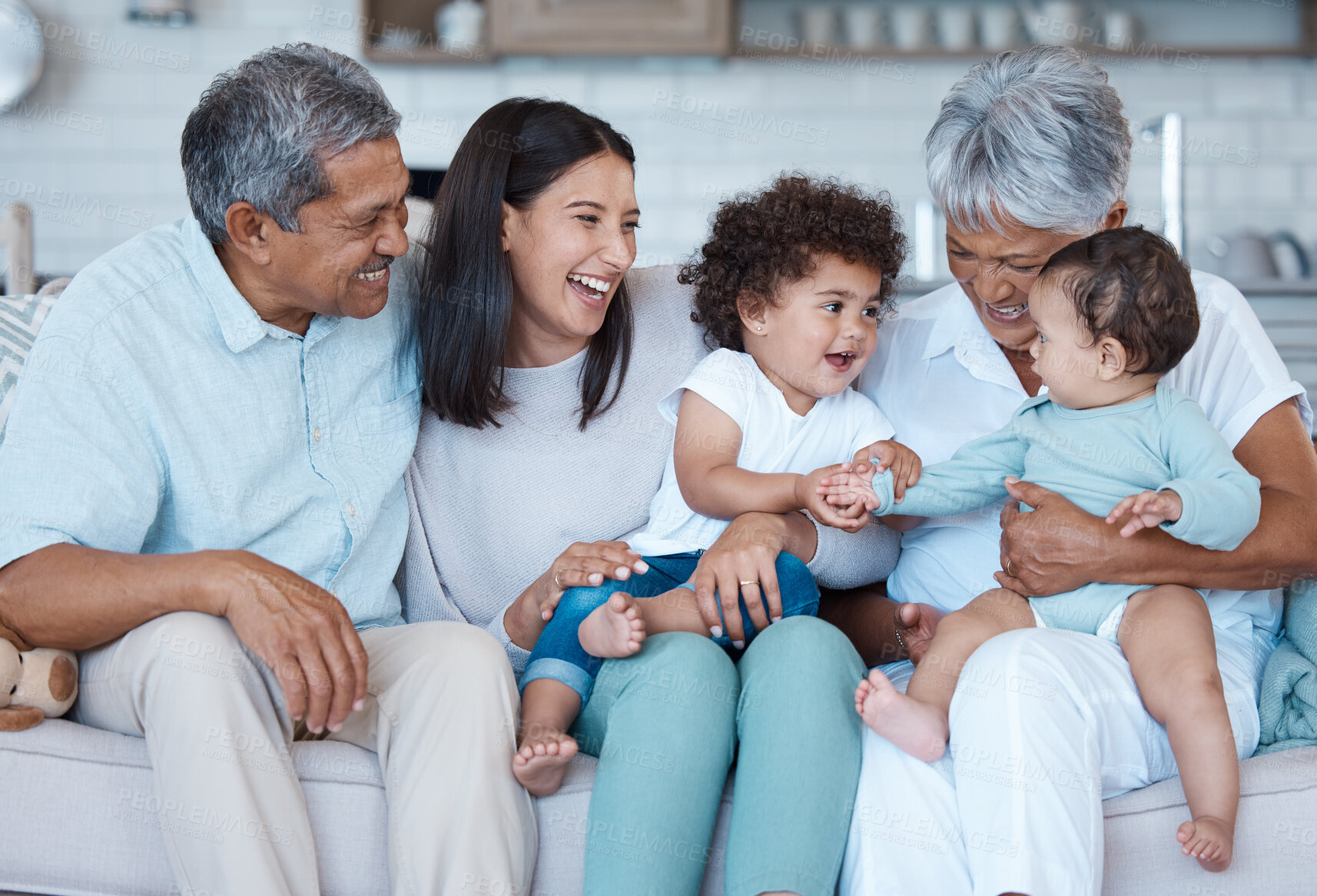 Buy stock photo Generations, playing and smile with family on sofa in living room of home together for bonding or visit. Happy, laughing or love with grandparents, mother and children in apartment or relationship