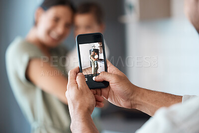 Buy stock photo Shot of a young mother taking a picture with her baby at home