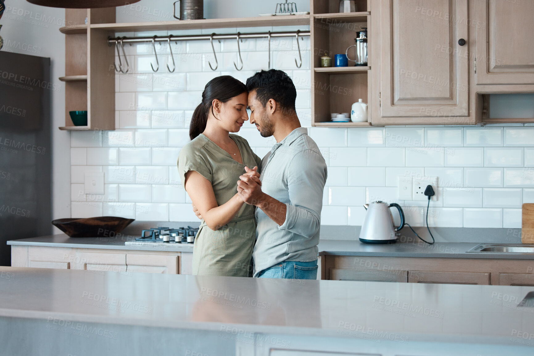 Buy stock photo Couple, relax and dancing with love in kitchen for bonding, support or embrace together at home. Young, man and  calm woman with affection or hug for romance, holiday or weekend in comfort at house