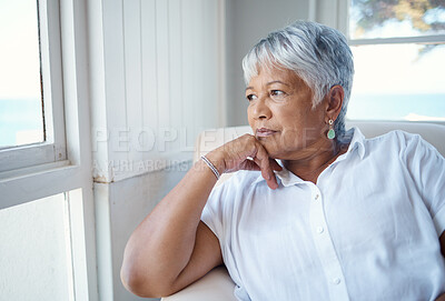 Buy stock photo Cropped shot of an attractive senior woman looking nostalgic while sitting in the old age home