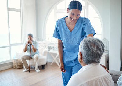 Buy stock photo Cropped shot of an attractive young female nurse doing her rounds in the old age home