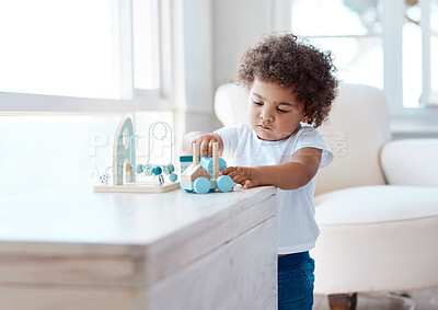 Buy stock photo Shot of a little girl playing with a toy at home