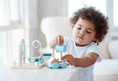 Buy stock photo Shot of a little girl playing with a toy at home
