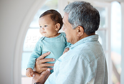 Buy stock photo Shot of a senior man spending time with his grandchild at home