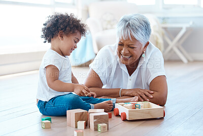 Buy stock photo Shot of a little girl playing with her grandmother at home