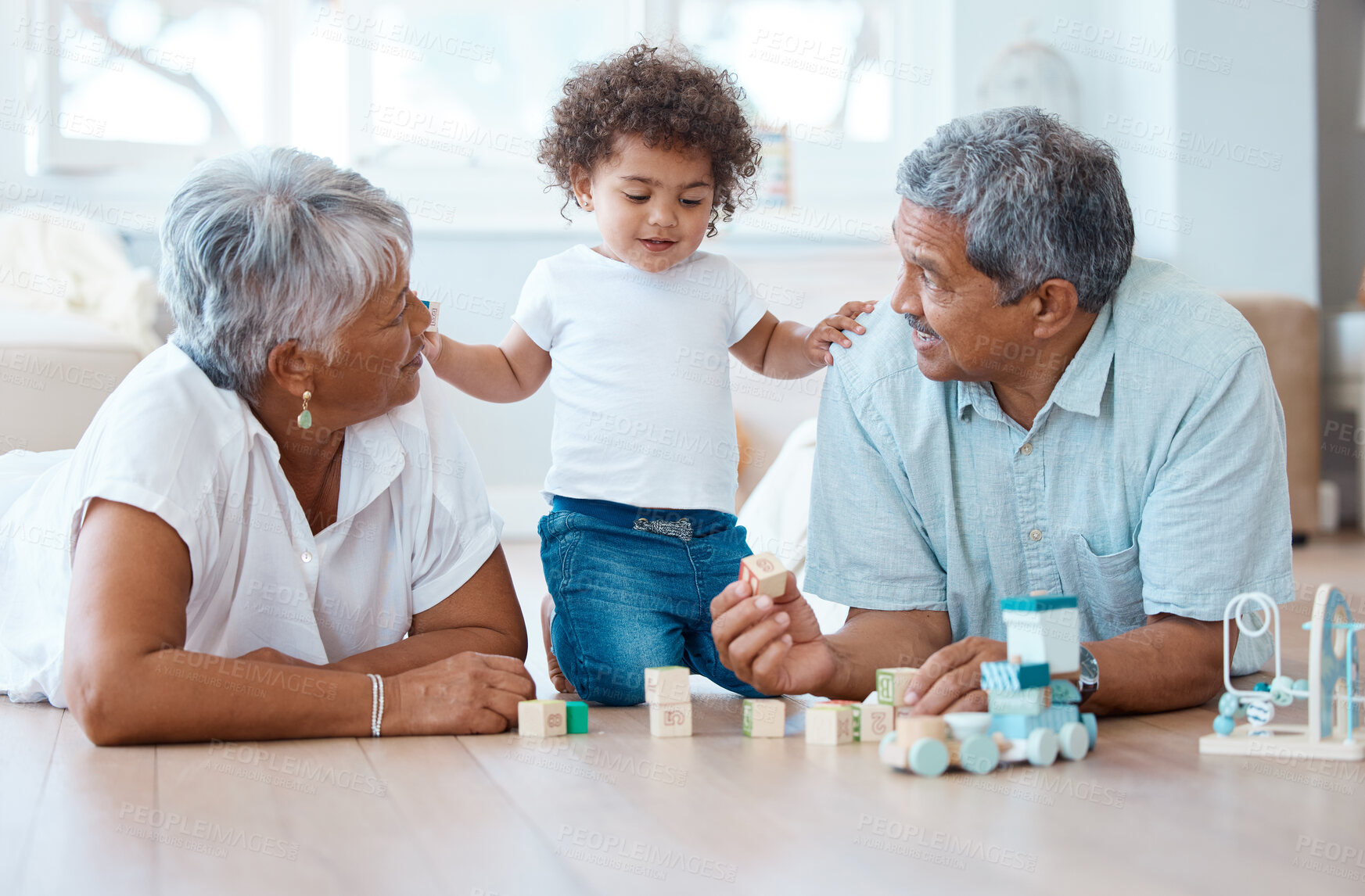 Buy stock photo Toys, bonding and baby with grandparents in home for learning, development or growth with help. Family, connection and toddler playing with senior people for cognitive skills with wood blocks.