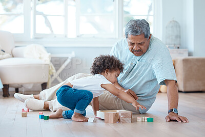 Buy stock photo Shot of a little girl playing with her grandfather at home