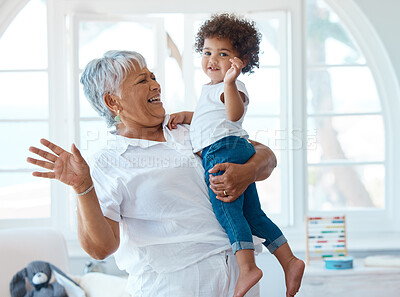 Buy stock photo Shot of a senior woman spending time with her grandchild at home