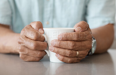 Buy stock photo Shot of an unrecognizable man drinking a cup of coffee at home