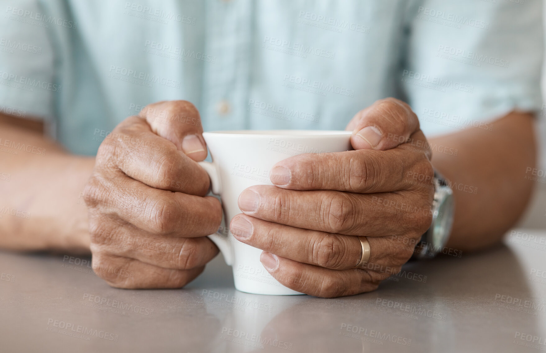 Buy stock photo Shot of an unrecognizable man drinking a cup of coffee at home