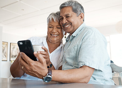 Buy stock photo Shot of a senior couple on a call together at home