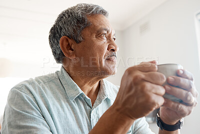 Buy stock photo Shot of a senior man drinking coffee at home