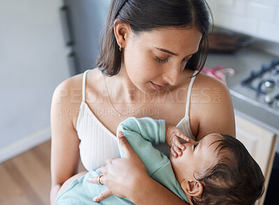 Buy stock photo Shot of a young mother bonding with her baby at home