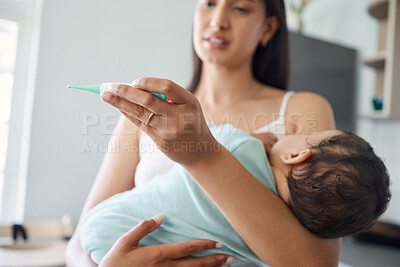 Buy stock photo Shot of a mother taking her baby's temperature at home