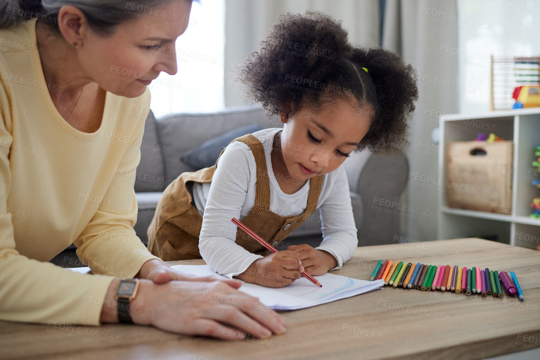 Buy stock photo Shot of a little girl drawing in a psychologists office