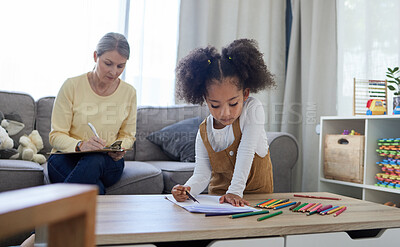 Buy stock photo Shot of a little girl drawing in a psychologists office