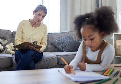 Buy stock photo Shot of a little girl drawing in a psychologists office